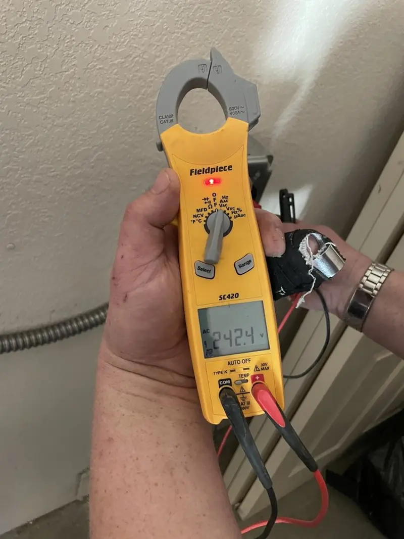 Voltage testing with clamp meter during Ceiling Fan Installation in Marion